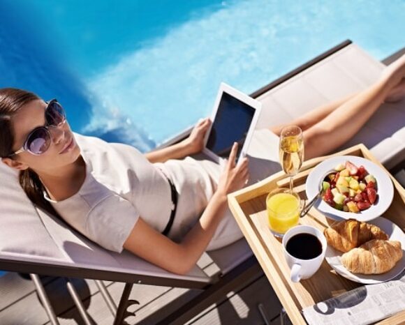 Frau liegt bei Geschäftsreise am Pool