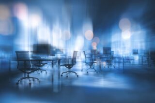 Büroarbeitsplätze im diffusen Dunkeln, symbolisieren Schwarzarbeit