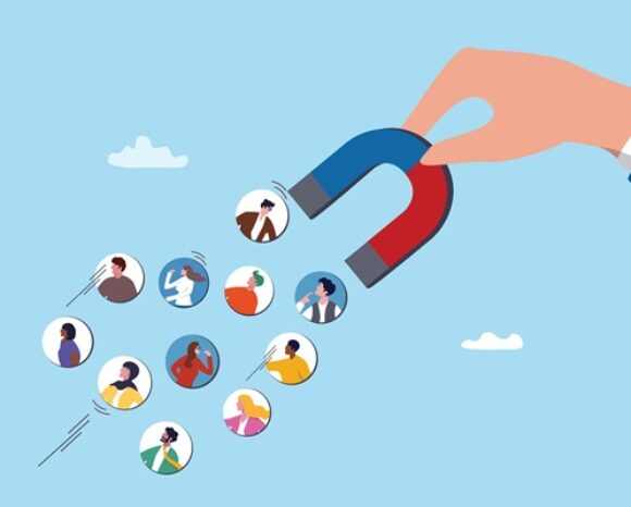 Mensch zieht mit einem Magneten kleine Menschen ein